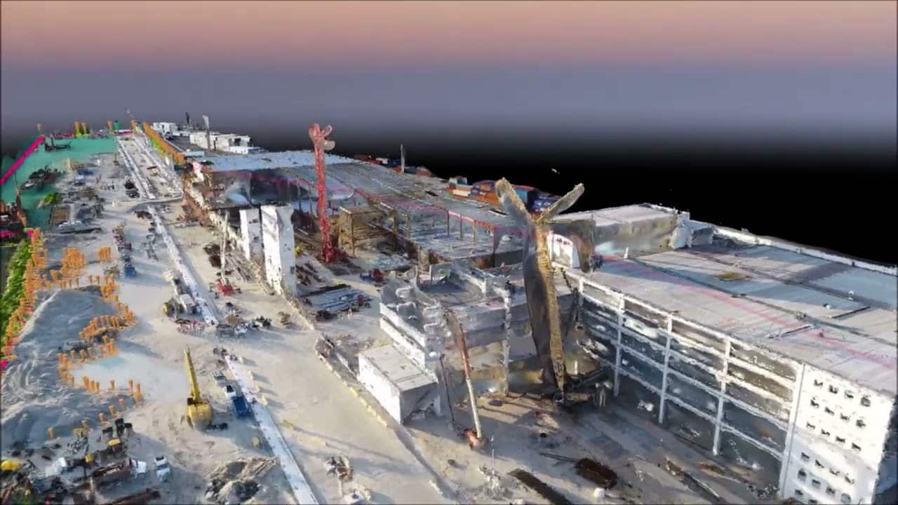3D drone photogrammetry model of a waterfront construction site with cranes and building structures