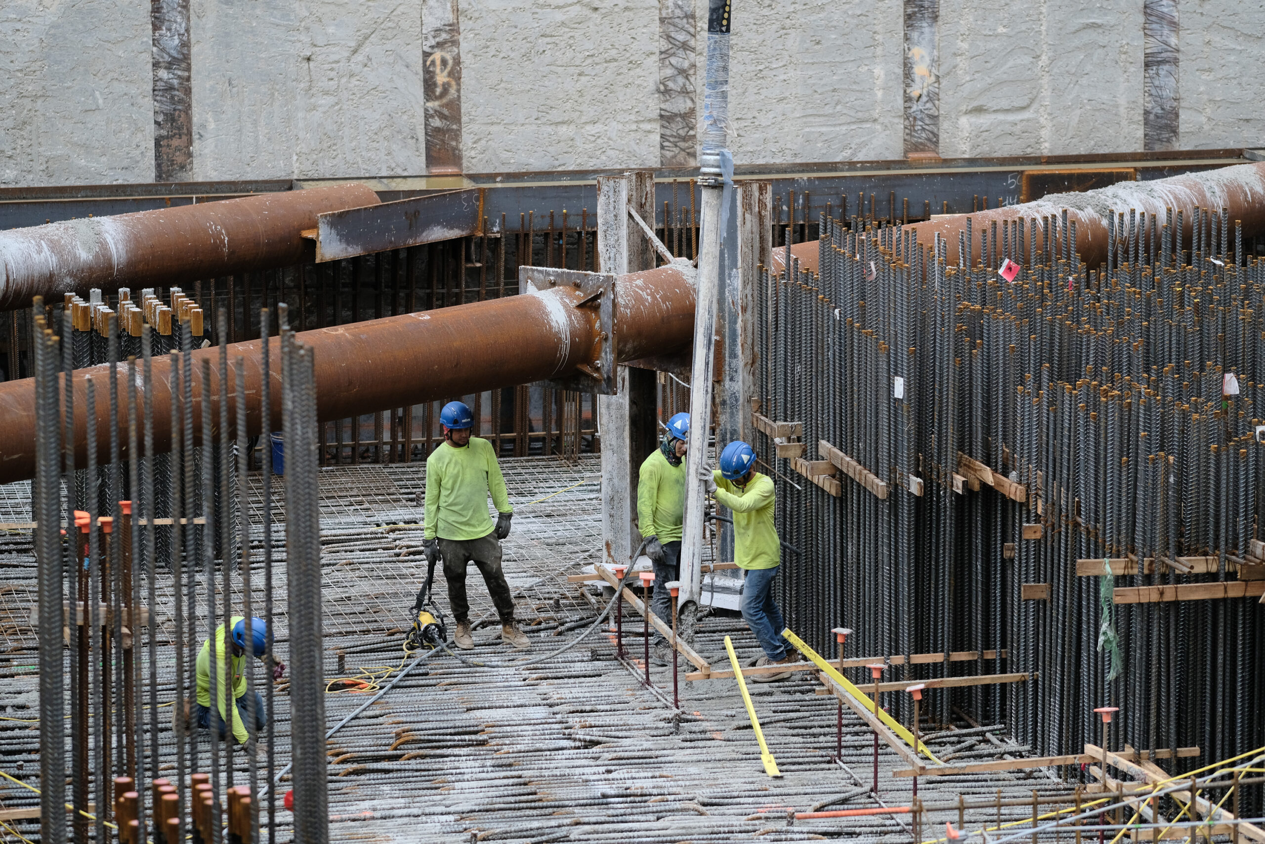 Construction workers among vertical rebar during the foundation mat pour at Waldorf Astoria Residences Miami, by Drone Permission