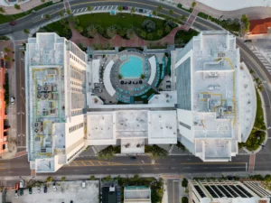 Top-down drone view of the Wyndham Grand hotel wings and circular pool deck