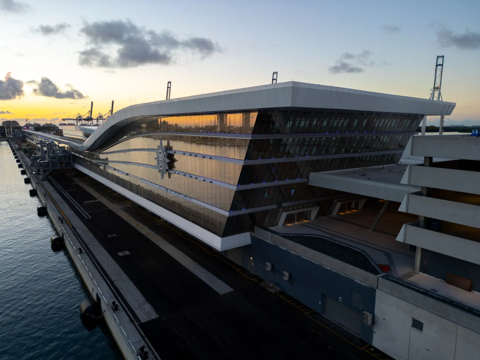 Modern glass MSC cruise terminal on the Miami waterfront at dawn
