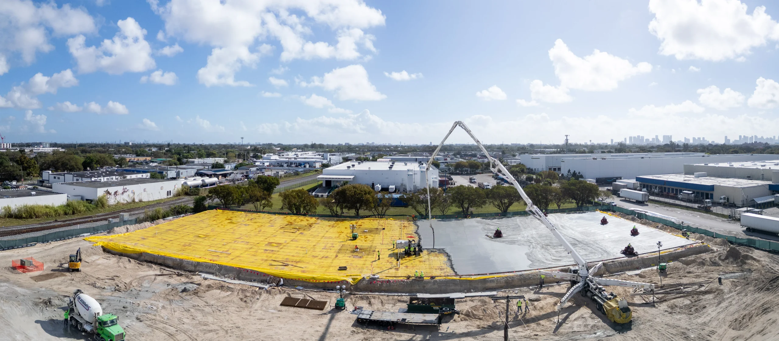 Wide aerial of a full foundation mat placement against the skyline at [WOODLAND PROJECT NAME], [CITY], documented by Drone Permission