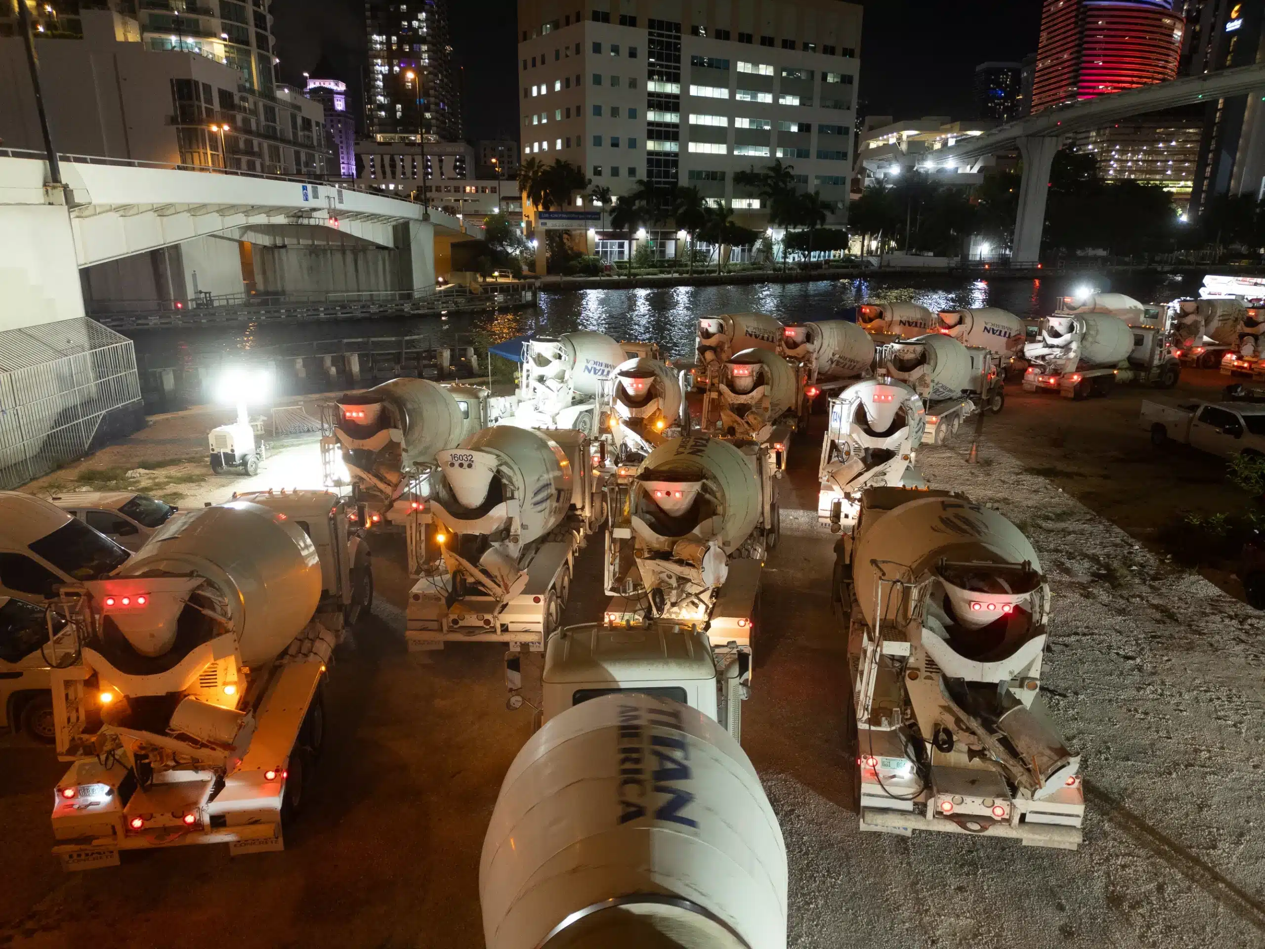Concrete trucks rotating through the staging area during the Baccarat Residences foundation pour in Brickell, Miami, photographed by Drone Permission
